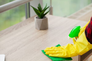 Beautiful Young Woman Wearing Protective Gloves Cleaning Desk Office