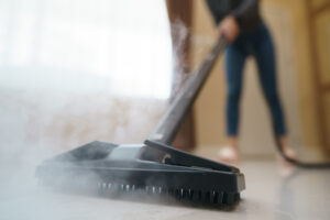 Woman Washes Floor With Steam Mop