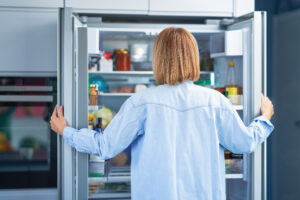 Young Adult Woman Kitchen With Fridge