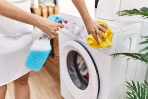 Young Hispanic Woman Cleaning Washing Machine Laundry Room 1