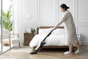 japanese woman vacuuming her bedroom