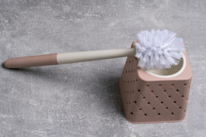 toilet cleaning brush gray background closeup