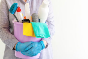 female cleaner holding bucket with cleaning supplies