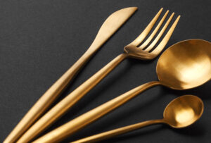 gold cutlery set black background